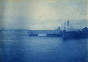 [Unidentified bridge structure being transported over water by tugboats]