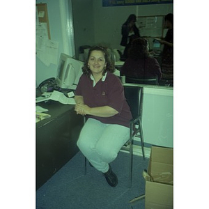 Woman sitting in an office, possibly an Inquilinos Boricuas en Acción staffer.