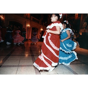 Girls in traditional dress perform a Puerto Rican folk dance for participants at Cultura Viva.