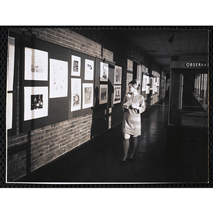 Barbara Gowan, Public Relations Assistant at the Museum of Science, views the Boys' Clubs of Boston Tri-Club Art Exhibit at the Museum of Science