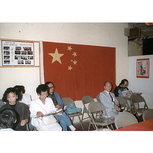 Guests and Chinese flag at a Chinese Progressive Association anniversary event