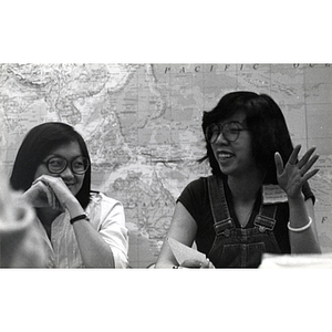 Two female members of the East Coast Asian Student Union sit at a meeting