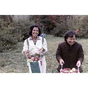 Women with apples during a Chinese Progressive Association trip