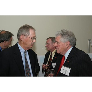 Dennis Picard converses with another man at the Veterans Memorial dinner