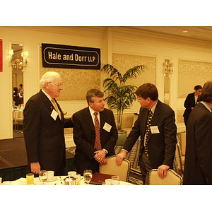 Three men talk following the College of Business Administration's CEO Breakfast Forum