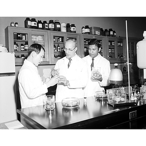 Professor A. Karim Khudairi in a biology laboratory with two graduate research students