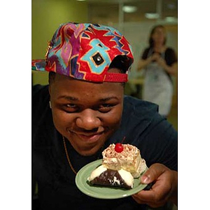 Ulysses Ifill holds his dessert at the Torch Scholars visit to the Exhibition Kitchen