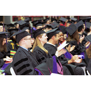 School of Law graduates clapping at commencement