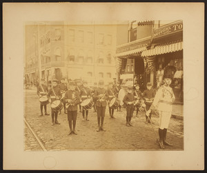 Informal group portrait of unidentified boys about to march in a parade