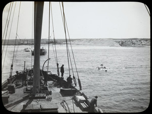 Men aboard vessel on the Cape Cod Canal