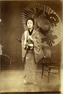 Japanese woman holding paper umbrella and sword