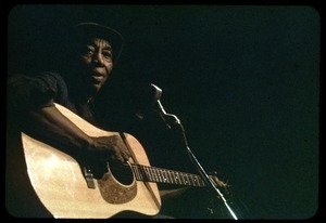 Mississippi John Hurt: in concert, playing guitar