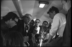 Robert F. Kennedy and the press aboard plane while stumping for Democratic candidates in the northern Midwest