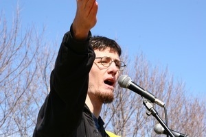 Unidentified speaker at the microphone, addressing protesters: rally and march against the Iraq War