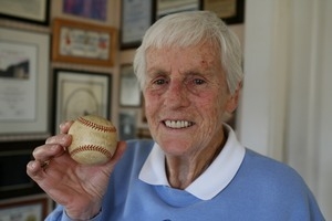 Wilma Briggs, formerly a star player in the All-American Girls Professional Baseball League, holding up a baseball she hit for a home run