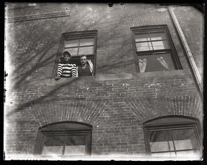 Two students looking out of a South College dorm window, Massachusetts Agricultural College
