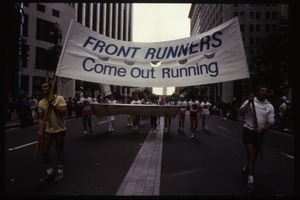 Men carrying sign 'Front Runners come out running' in the San Francisco Pride Parade