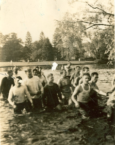 Rope pull participants wading in campus pond