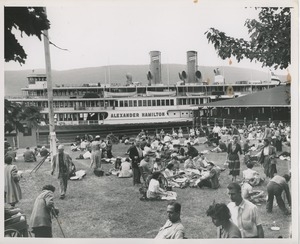 Crowds eating lunch on picnic grounds