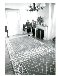 Florence and Paul Freitas by fireplace in Commonwealth House