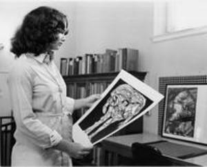 A woman views a print in the Chapin Library