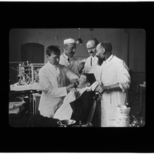 Doctors performing dental work on a patient