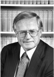 Suffolk University Professor (Law) and Dean (1994-1998) John E. Fenton, Jr., with bookshelf in background