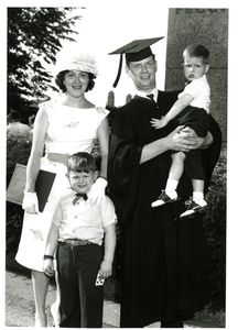 A graduate poses with his family at the 1962 Suffolk University commencement