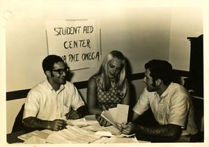 Members of Suffolk University's Alpha Phi Omega National Service Fraternity chapter man a student aid center, circa 1960s