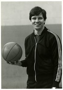 Suffolk University Athletics Director James E. Nelson holding basketball, portrait