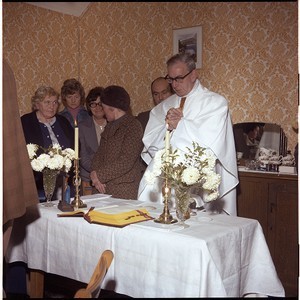 Local priest saying Mass in a house in Downpatrick