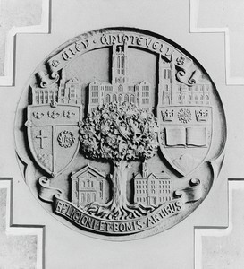 Photograph of a possible early seal of Boston College. Seal contains a BC crest, Jesuit crest, and buildings from both the current BC campus and the original campus