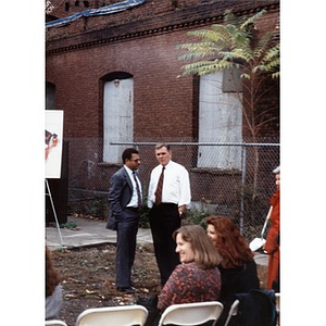 Mayor Flynn conversing with an unidentified man during the ground breaking ceremony for Taino Tower.