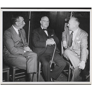 J. Willard Hayden, at center, looks at the camera while conversing with an unidentified man, at left, and Arthur T. Burger, Executive Director of the Boys' Clubs of Boston