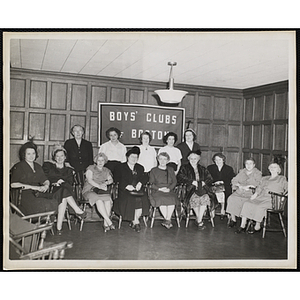 Members of the Mothers' Club pose for a group shot in front of a "Boys' Club of Boston" banner