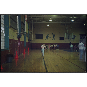 A child runs across a gymnasium floor