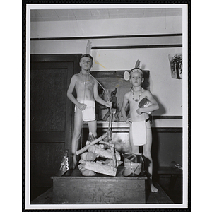 Two boys standing with objects from their Indians club