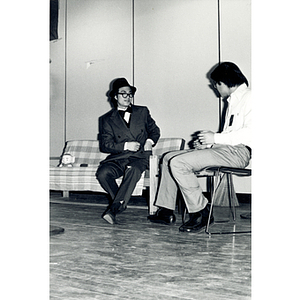 Two men perform a theatrical sketch onstage at the Josiah Quincy School about the normalization of U.S. and China relations