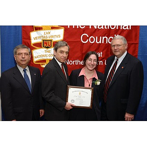 An unidentified inductee poses with her certificate and three others at The National Council Dinner