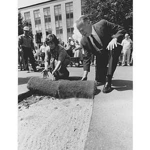 Kenneth Ryder and Kitty Dukakis lay sod in the Quadrangle for the "Beautify Open Spaces" dedication
