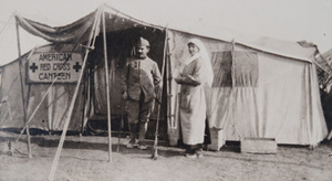 Margaret Hall and a soldier standing outside an American Red Cross canteen tent