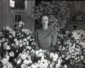 Daughter of Ben Niseketm [sic], seated indoors among blooming azaleas in pots