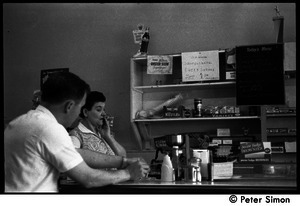 Customer and waitress at the counter of a diner