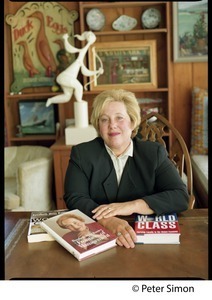 Rosabeth Moss Kanter, seated at a table with her books
