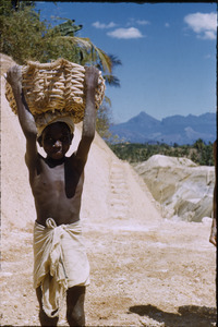 Boy carrying gravel