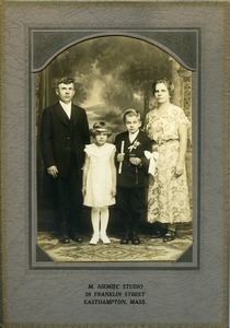 Lesinski family (Jan and Weronika, with children Stanley and Marya) at First Communion: full-length studio portrait of Polish American family