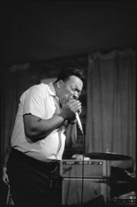 James Cotton at Club 47: James Cotton playing harmonica into a microphone onstage