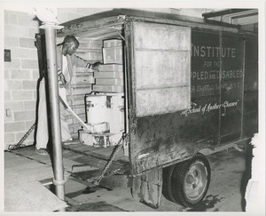 Unidentified man loading boxes onto a truck