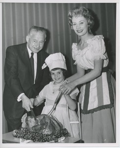 Abe Stark and Candace Hilligoss carving turkey with young client
