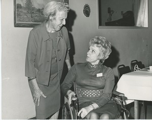 Mrs. Frank Russell with a client in a wheelchair at Thanksgiving